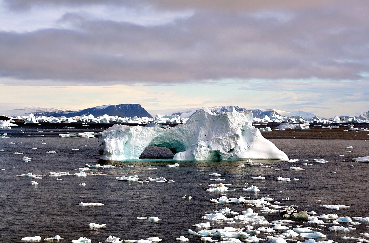 Melting iceberg with hole in middle